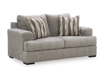 Gray loveseat with padded arms and two seat cushions, styled with striped throw pillows