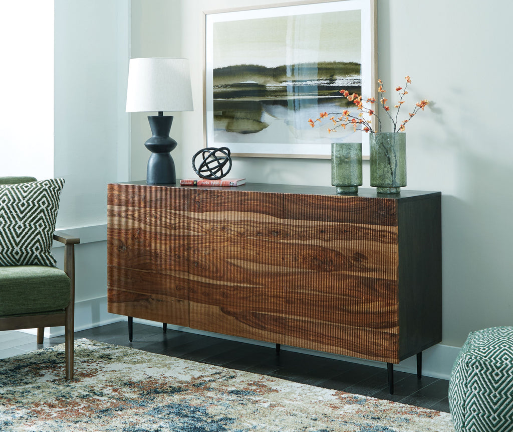 Brown wood accent cabinet with dark legs, three front drawer-like panels