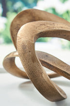 Antique brass metal sculpture close-up of interlocking oval loop shapes