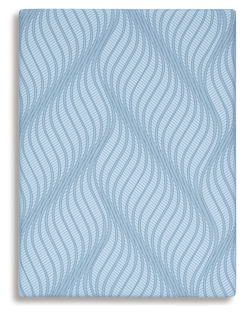 Blue mattress cover with repeating wavy line pattern on top surface