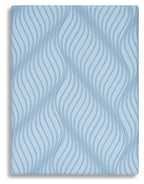 Blue mattress cover with repeating wavy line pattern on top surface