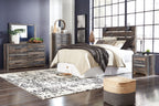 Bedroom furniture set in dark gray with beige bedding, bed, dresser, mirror, chest