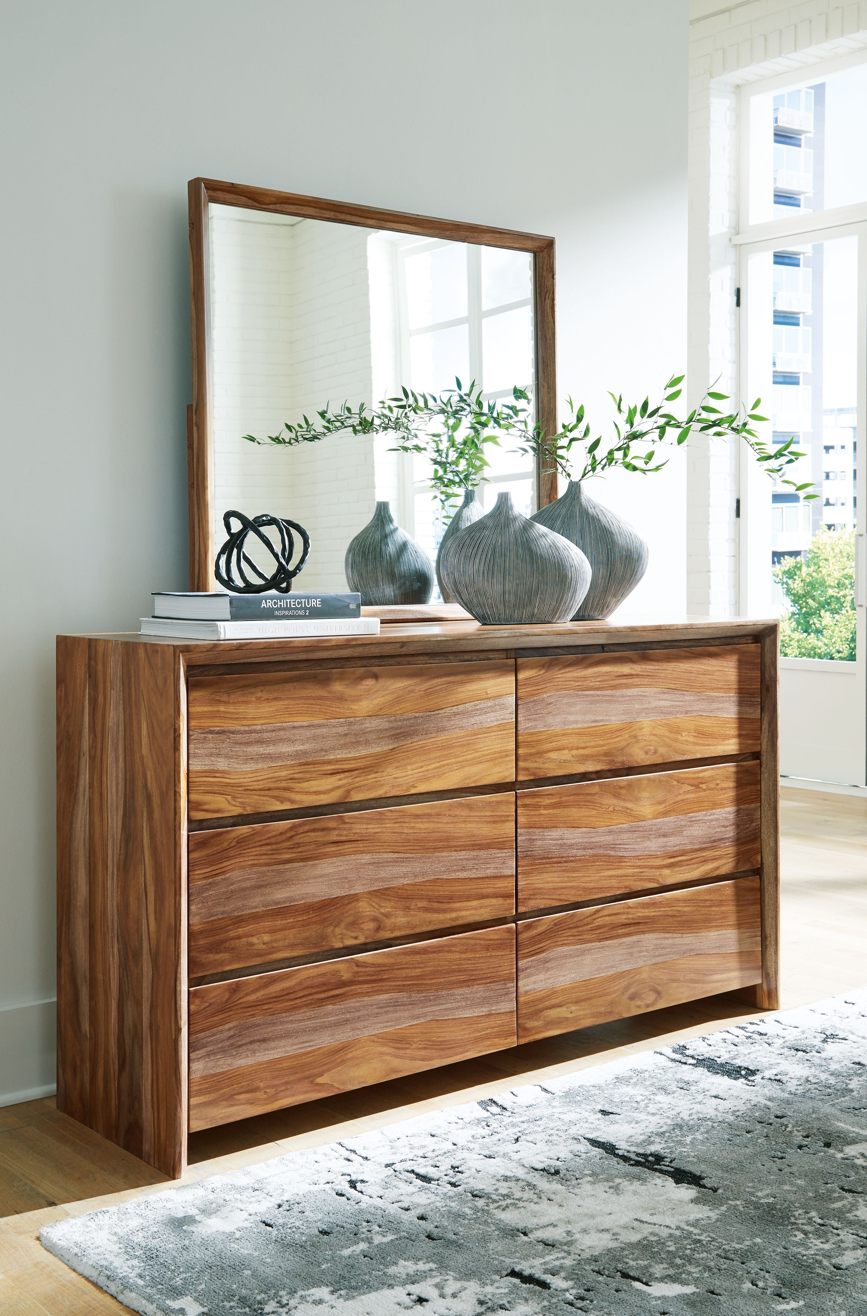 Brown wood dresser with tall mirror and drawer storage