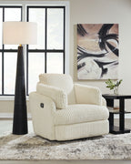 Ivory ribbed swivel glider recliner with reclined seat and padded headrest.