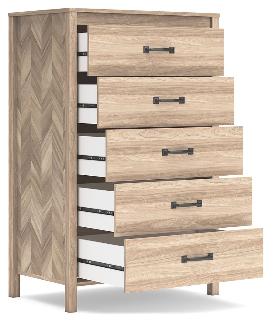Tan five-drawer chest with black bar handles, chevron side panel, side view