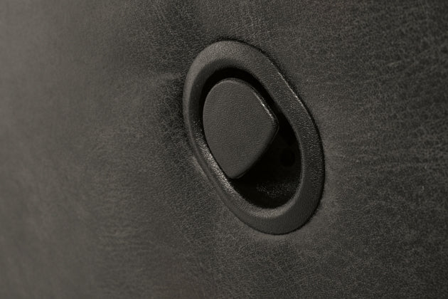 Close-up of pewter fabric rocker recliner armrest surface with stitched seam.