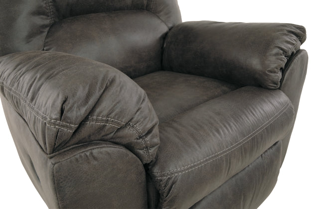 Pewter rocker recliner chair arm and seat cushion with visible stitching.
