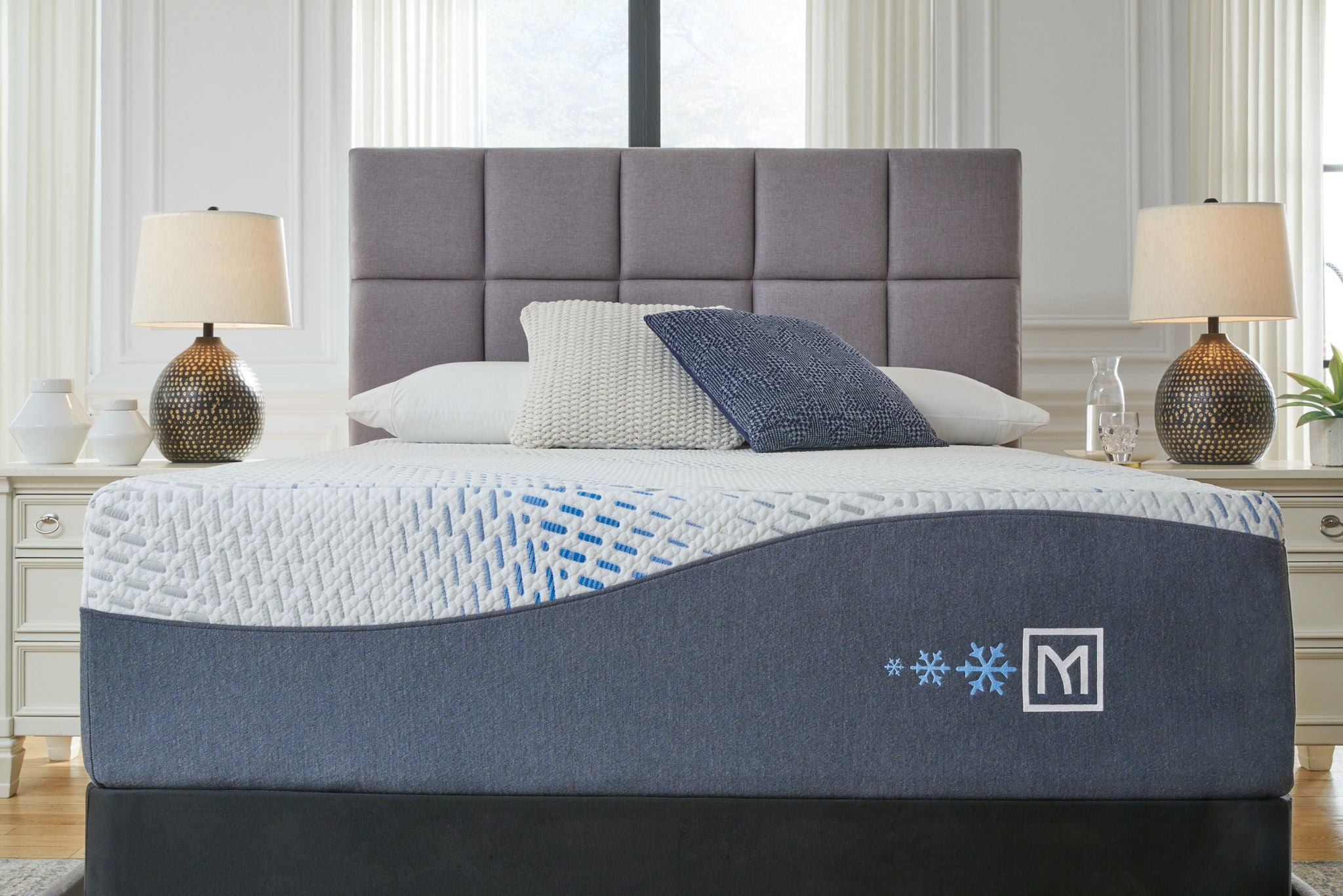 Hybrid gel latex mattress with white patterned top and blue base with emblem