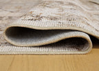 Washable rug edge close-up with light woven texture and bound rug border
