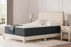 Hybrid mattress on bed with dark gray quilted cover and white bedding