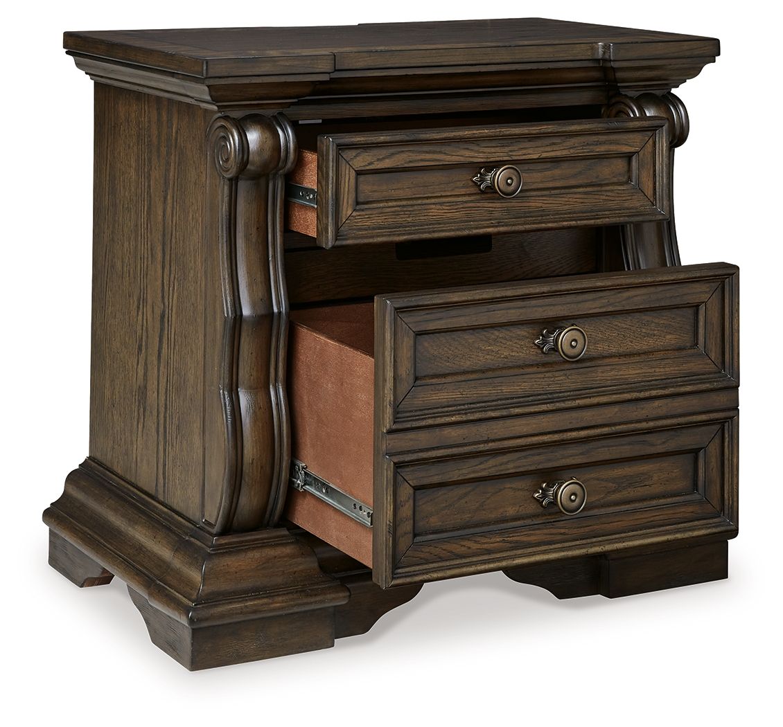 Dark brown three-drawer night stand with carved legs and metal drawer pulls