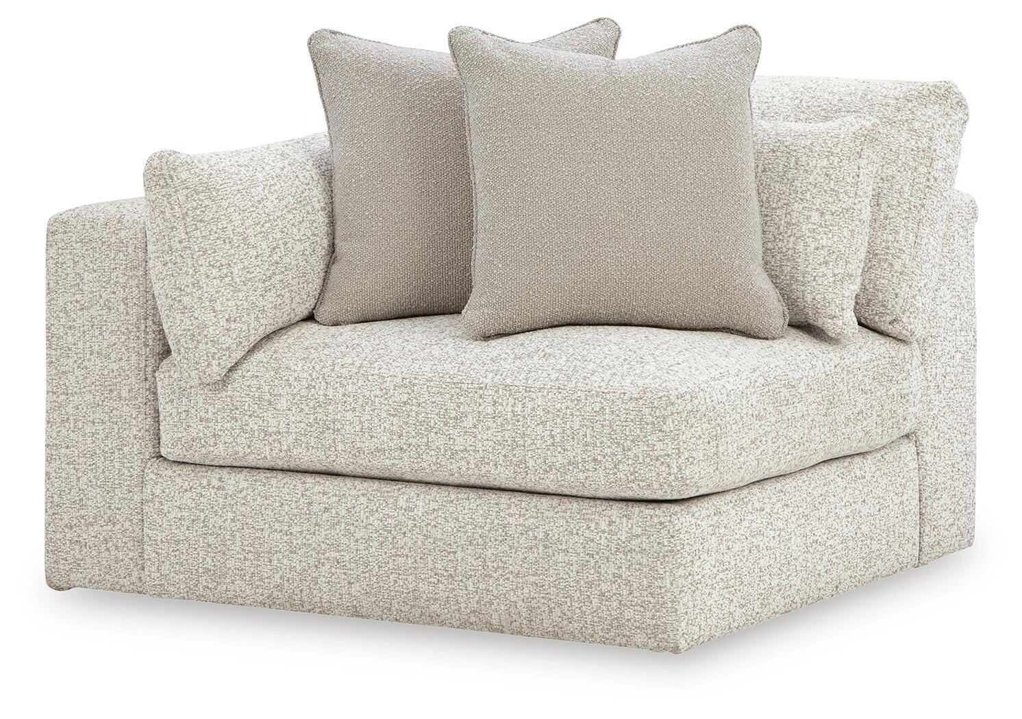 Light textured corner chair with wide seat, short arms, and four square throw cushions