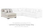Sectional corner chaise unit with light upholstery, black legs, and a raised seat cushion