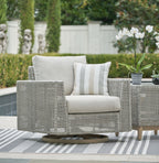 Gray swivel lounge chair with woven frame, light cushion, and striped throw pillow