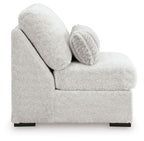 Light gray armless chair with rounded arms, plush seat, and patterned lumbar pillow