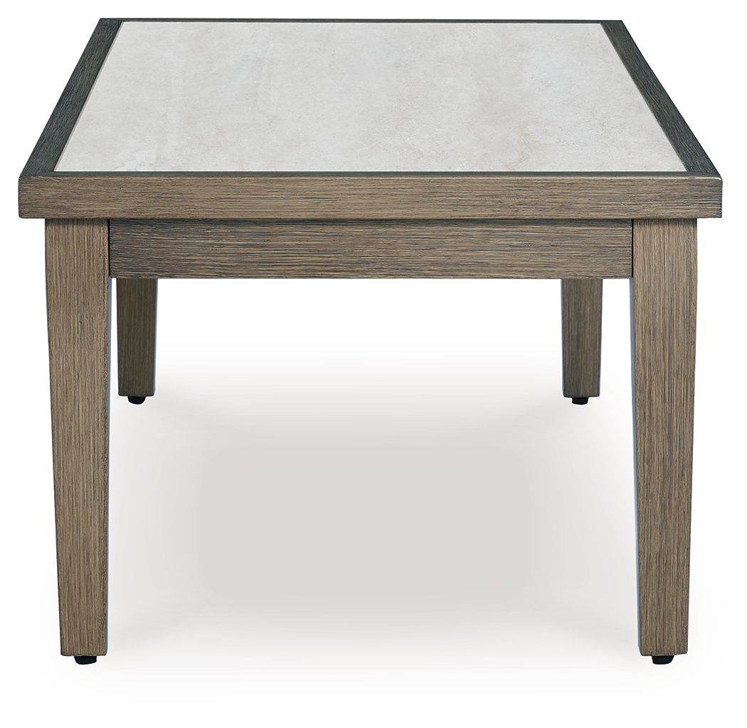 Rectangular cocktail table with light tabletop panel and dark edge trim, brown legs