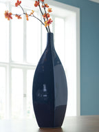 Glazed blue ceramic vase with narrow neck and blooming branches