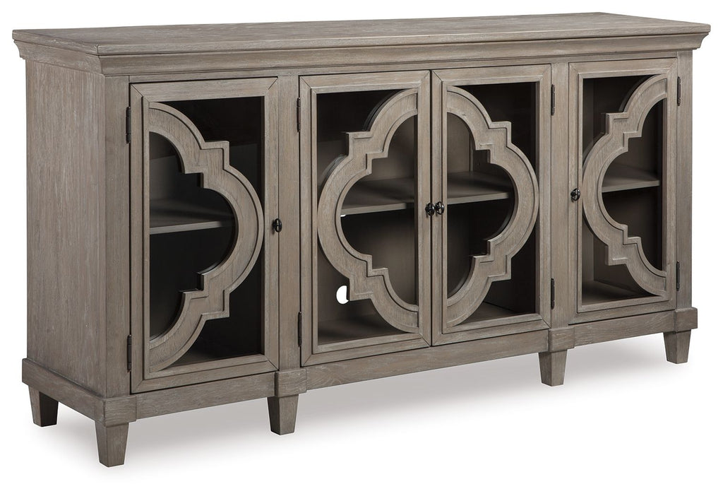 Gray accent cabinet with four doors, arched cutout panels, and tapered legs