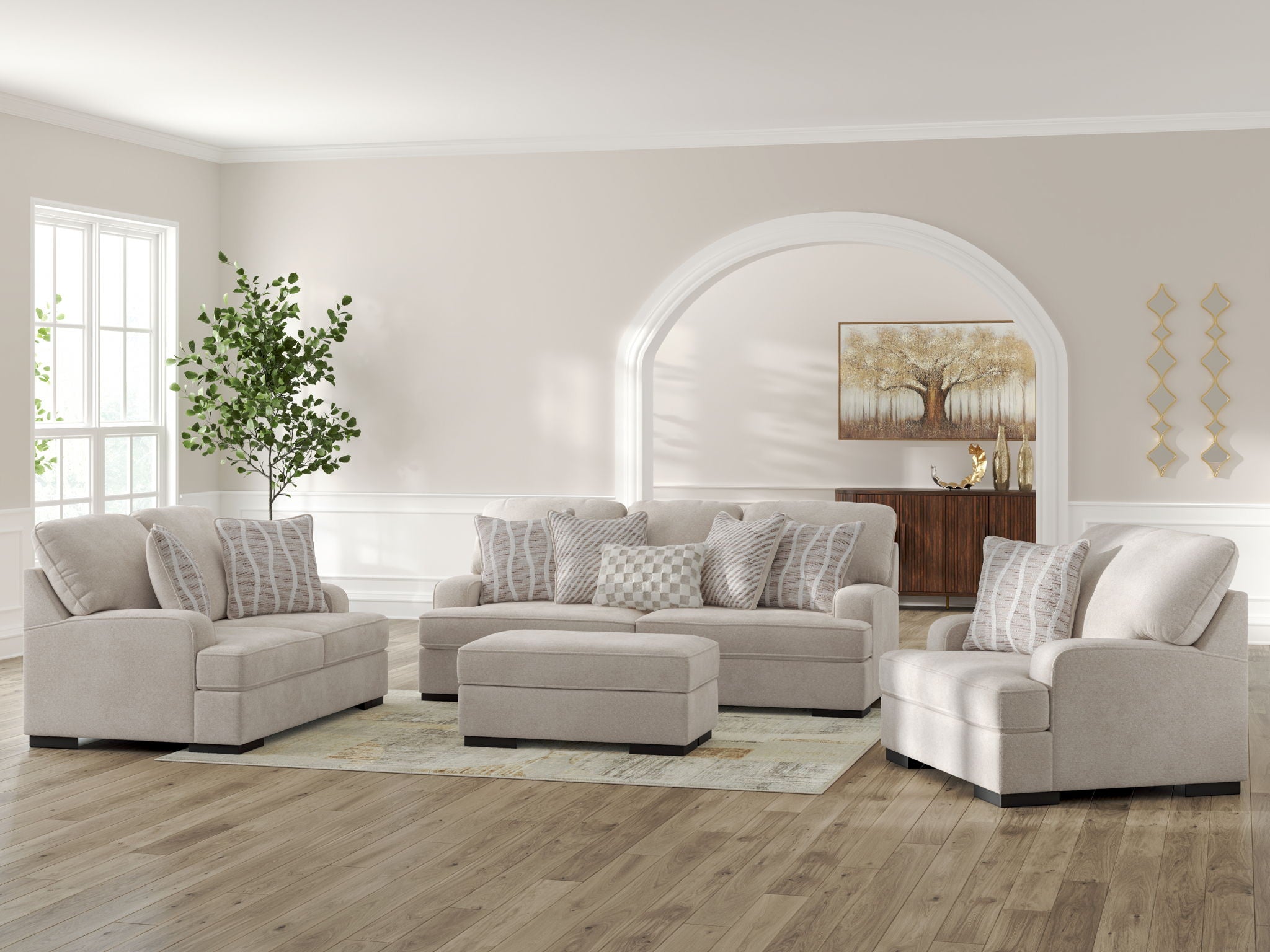 Beige living room seating set with striped throw pillows and matching ottoman