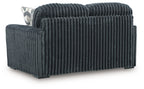 Dark gray corduroy loveseat, side view with ribbed fabric and rounded armrest