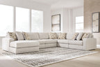 Light beige sectional sofa with corner chaise and patterned throw pillows.