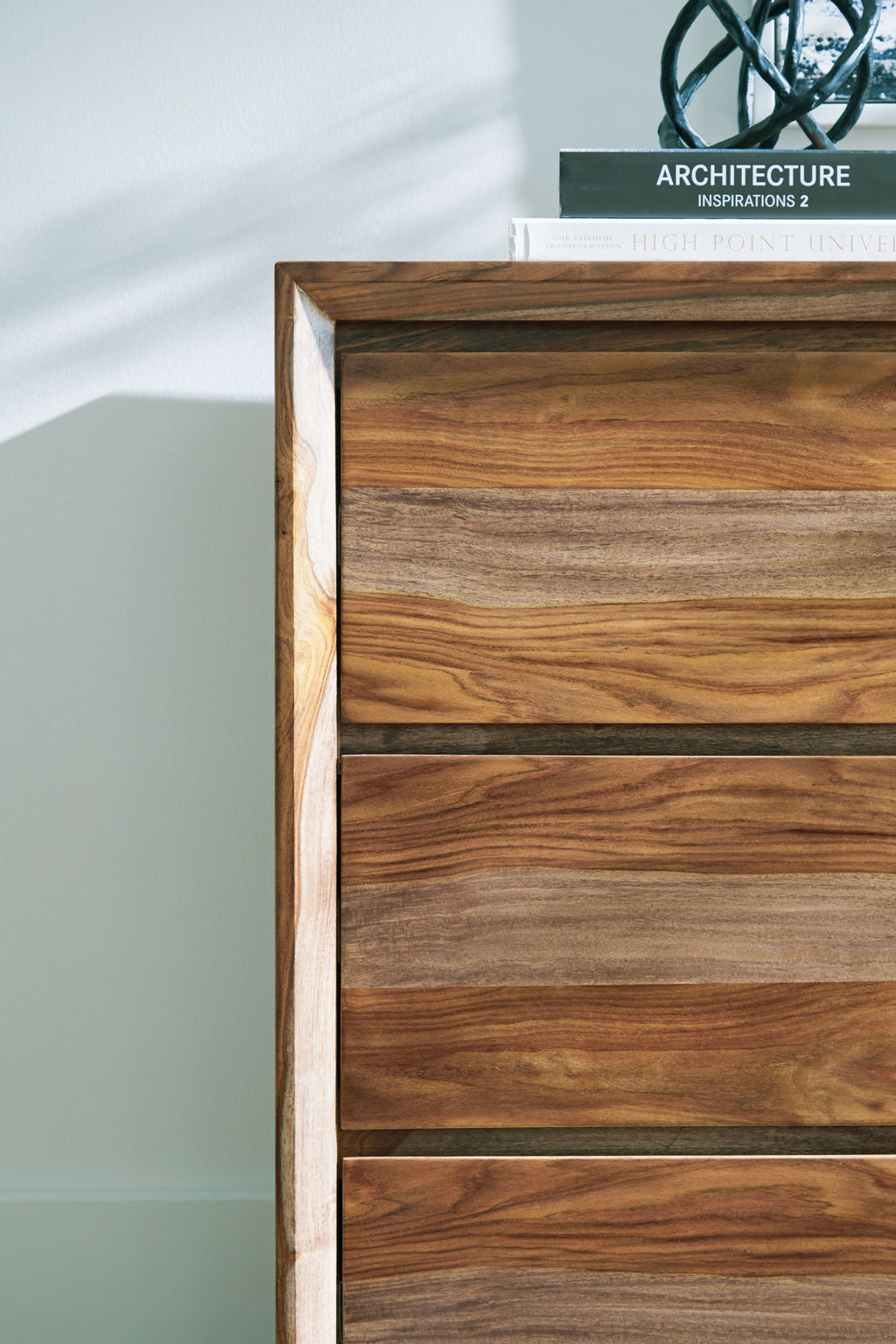 Brown wood dresser drawer fronts with visible wood grain texture