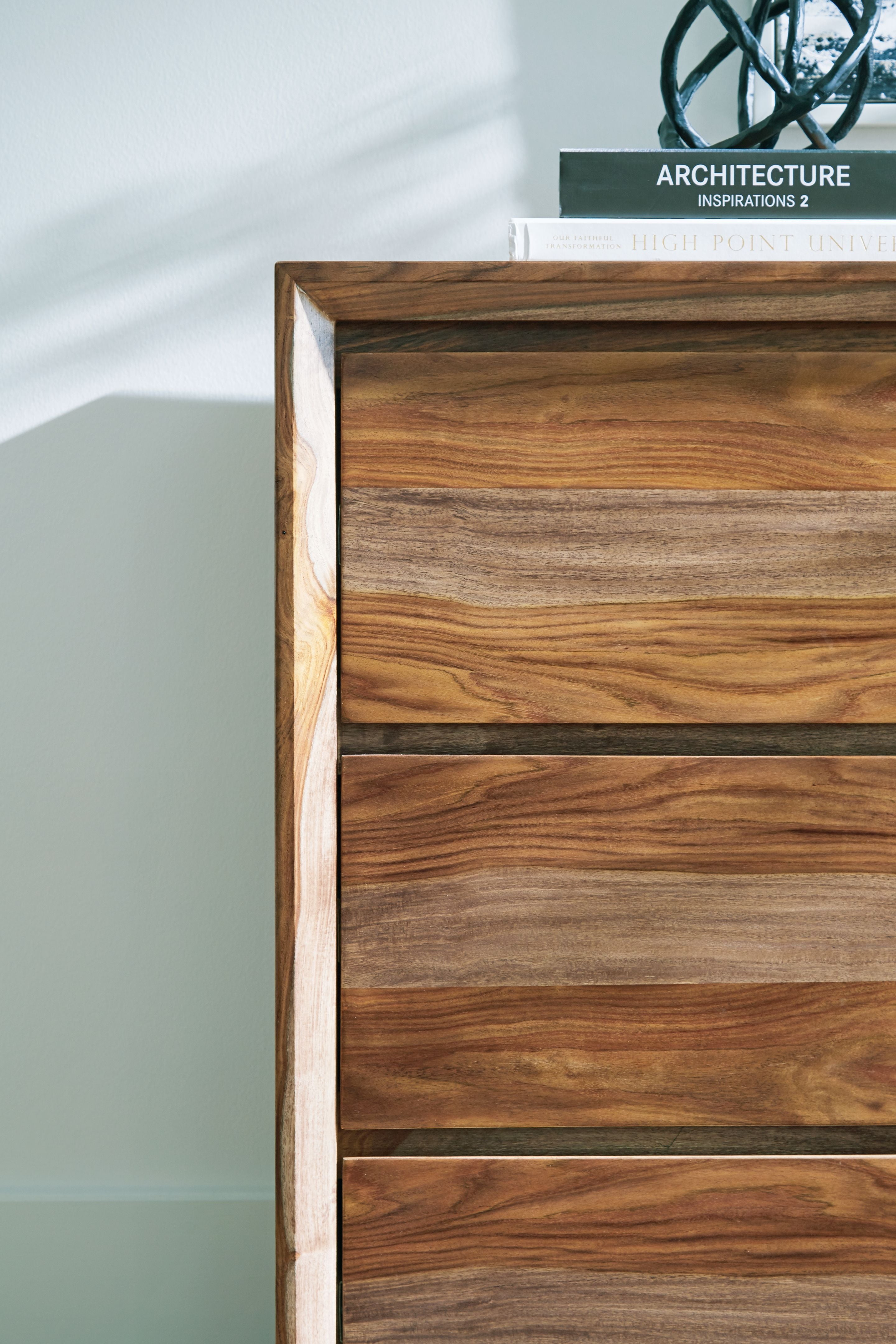 Brown wood dresser drawer fronts with visible wood grain texture