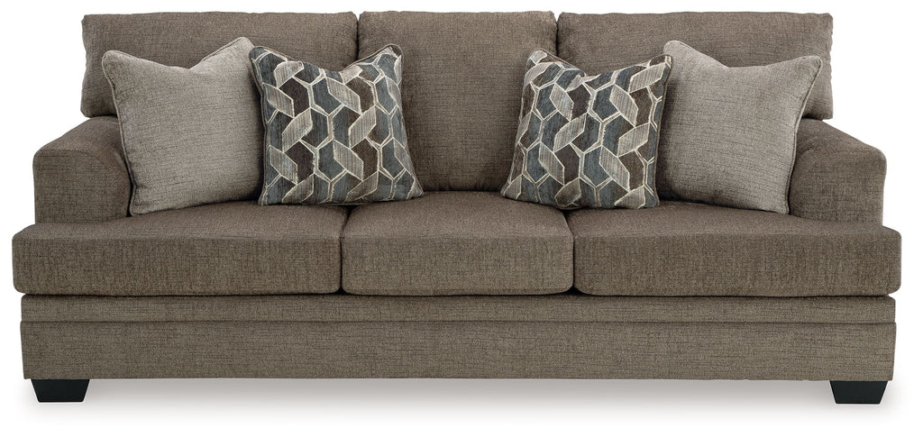 Stonemeade sofa, dark taupe fabric, with four accent pillows and geometric patterns