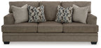 Stonemeade sofa, dark taupe fabric, with four accent pillows and geometric patterns