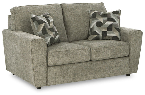 Light gray loveseat with two seat cushions and two patterned throw pillows