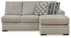 Sofa chaise sectional with light gray upholstery, wide chaise ottoman and patterned cushion
