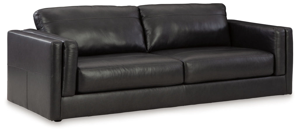 Black leather sofa with box cushions and rolled backrest