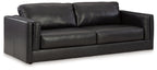 Black leather sofa with box cushions and rolled backrest