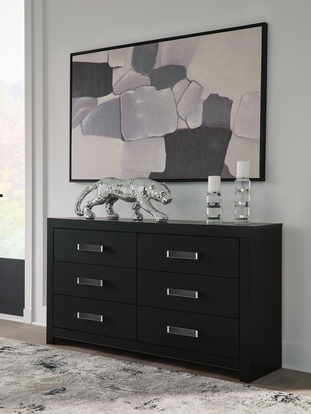 Black six-drawer dresser with six drawers and silver bar handles, front view.