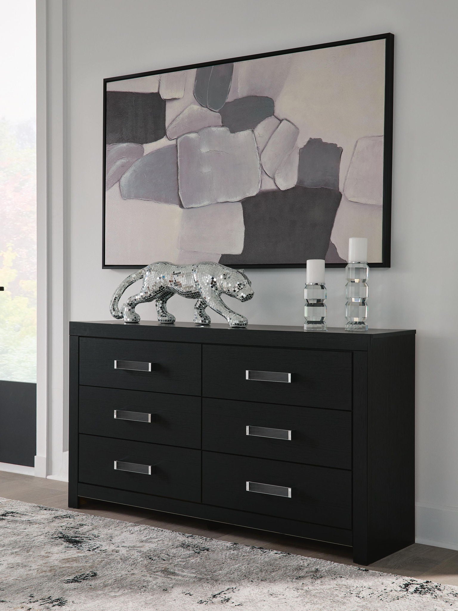 Black six-drawer dresser with six drawers and silver bar handles, front view.