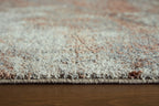 Close-up of rug fibers on a beige and gray distressed abstract pattern