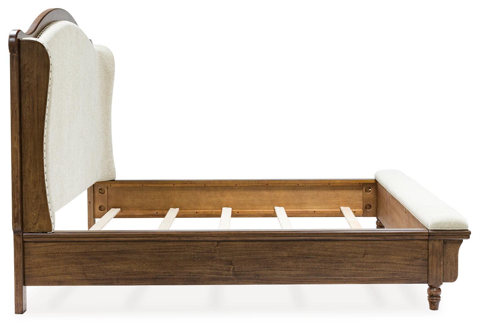 Upholstered panel bed with cream side panel, dark brown wood frame and slatted base