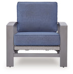 Blue upholstered lounge chair with gray frame, cushioned seat, and woven lower support