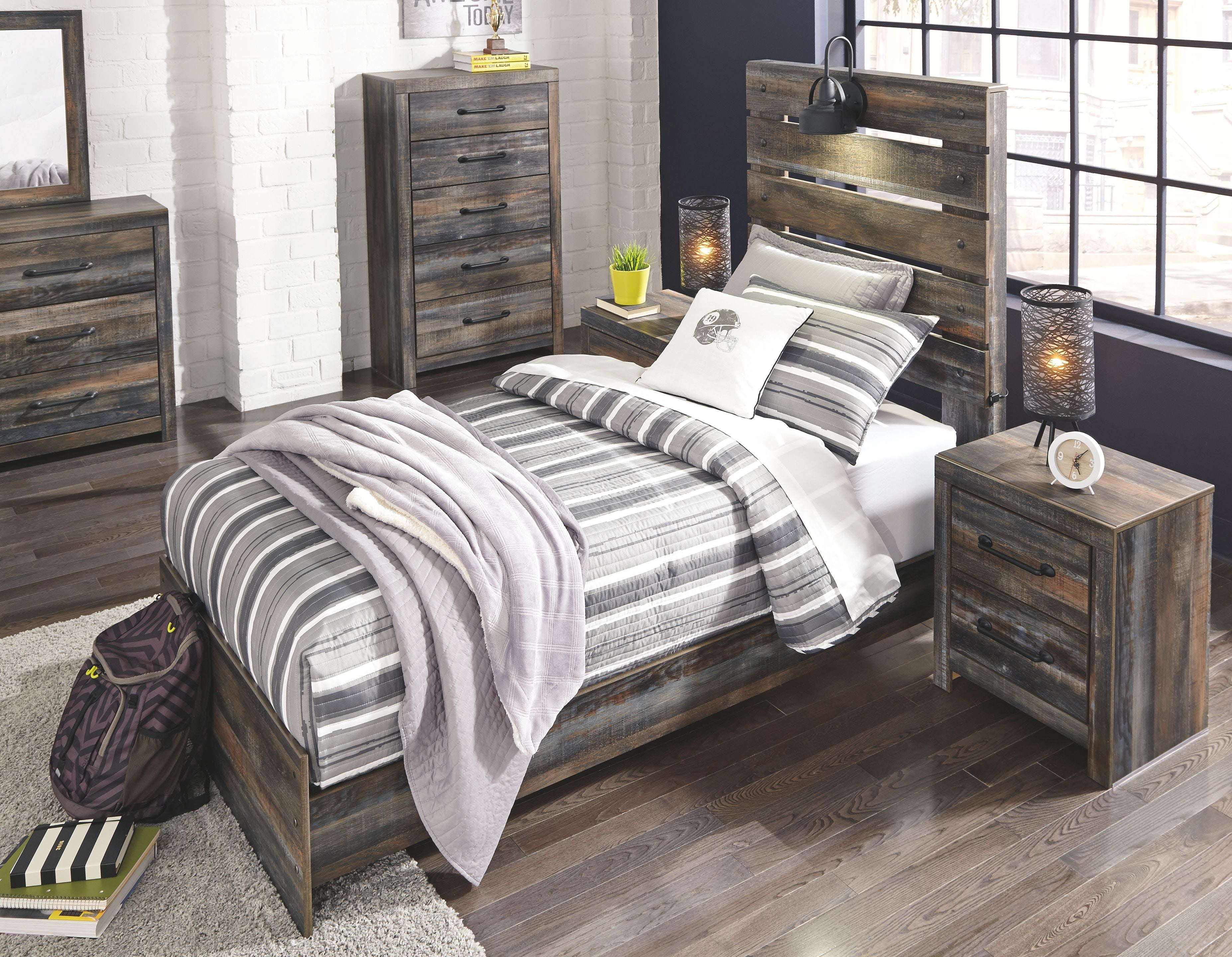 Youth panel bedroom set with gray wood bed and matching nightstand; striped bedding