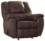 Brown leather rocker recliner with padded armrests, cushioned seat, and recline footrest