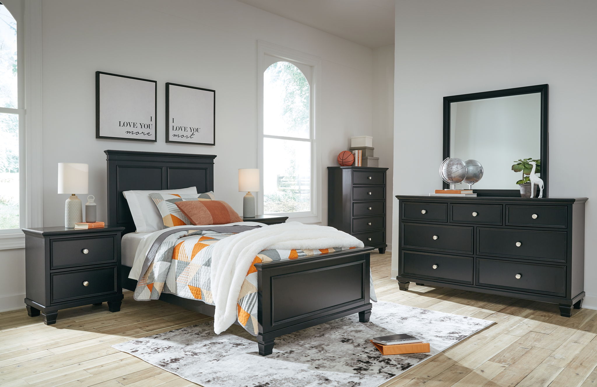 Black bedroom furniture set with bed, nightstands, dresser, and framed mirror