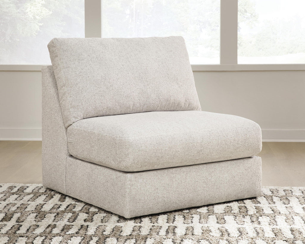 Light beige armless accent chair with thick seat and rounded back