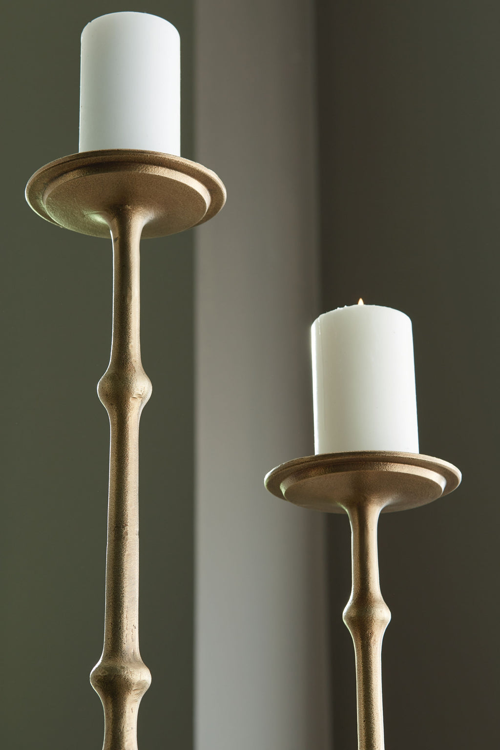 Antique brass candle holders with flared rims and beaded stems