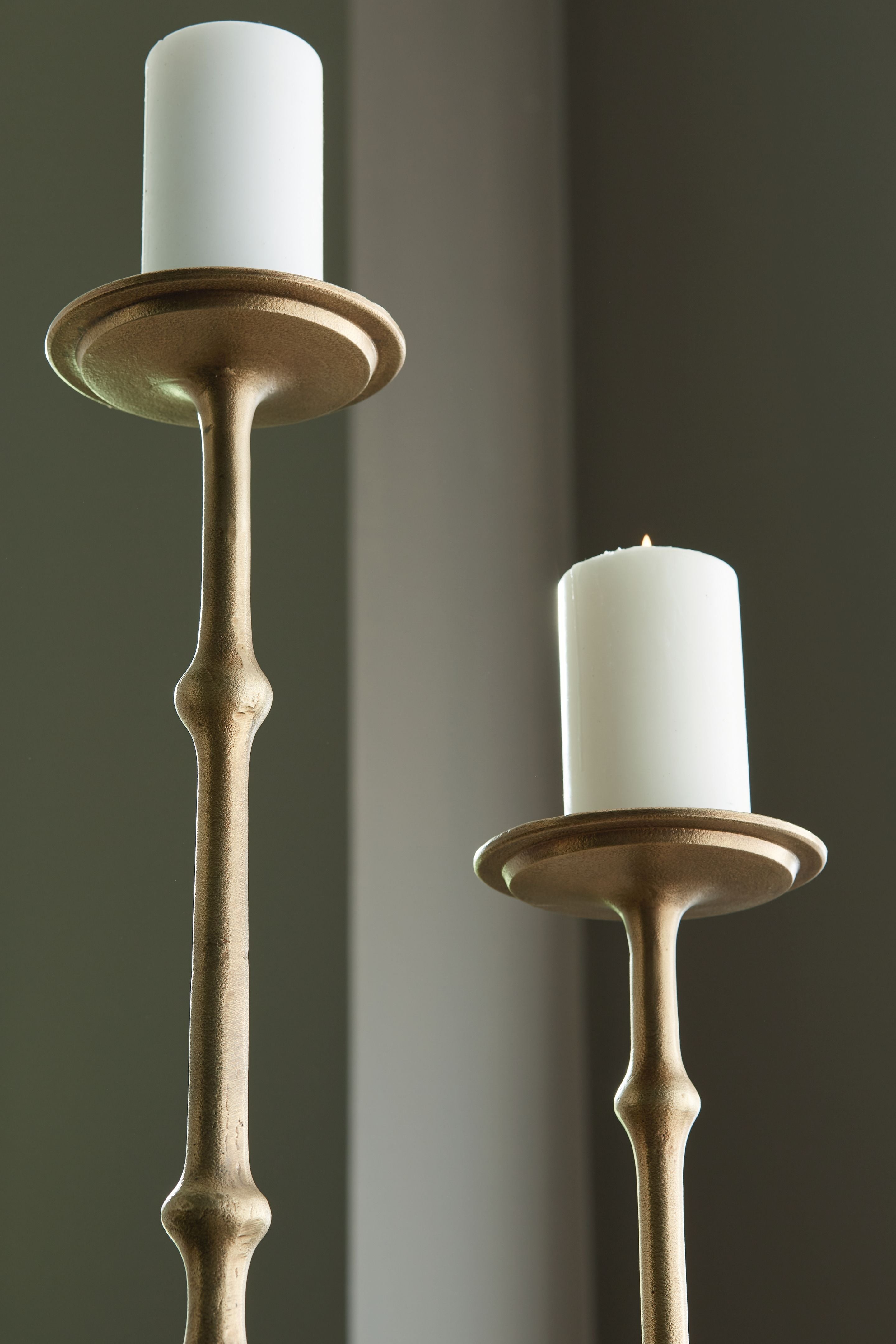 Antique brass candle holders with flared rims and beaded stems