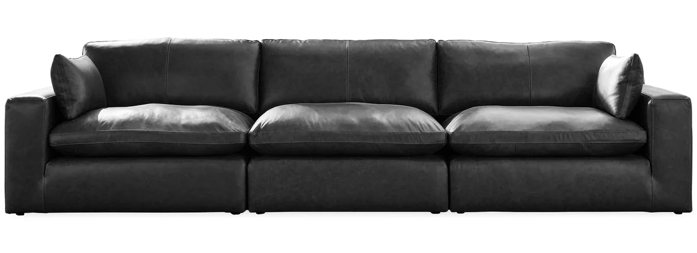 Black sectional sofa with three-seat layout, low arms, and deep seat cushions