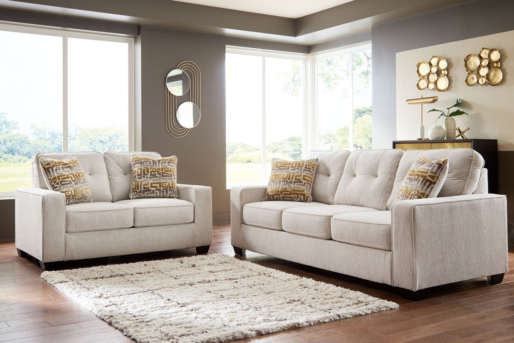 Beige fabric sofa and recliner set with patterned throw pillows
