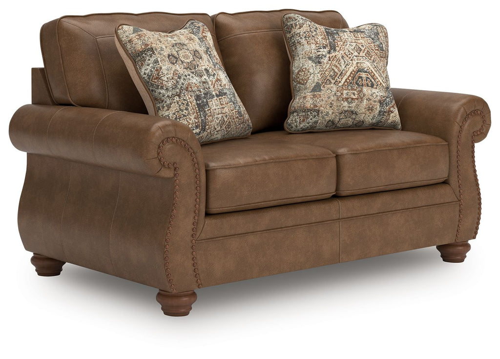 Dark brown loveseat with two patterned square throw pillows and rolled arms