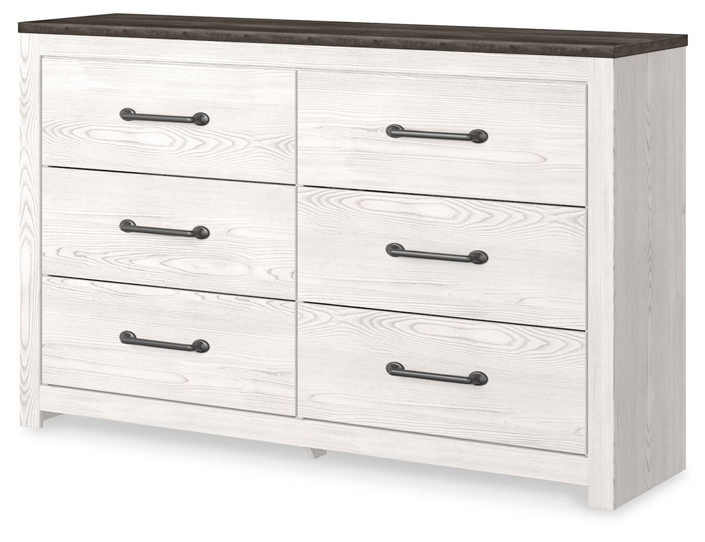 White panel dresser with dark top and four drawers with bar pulls