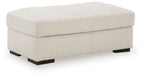 Light beige linen ottoman with padded upholstered top and dark legs
