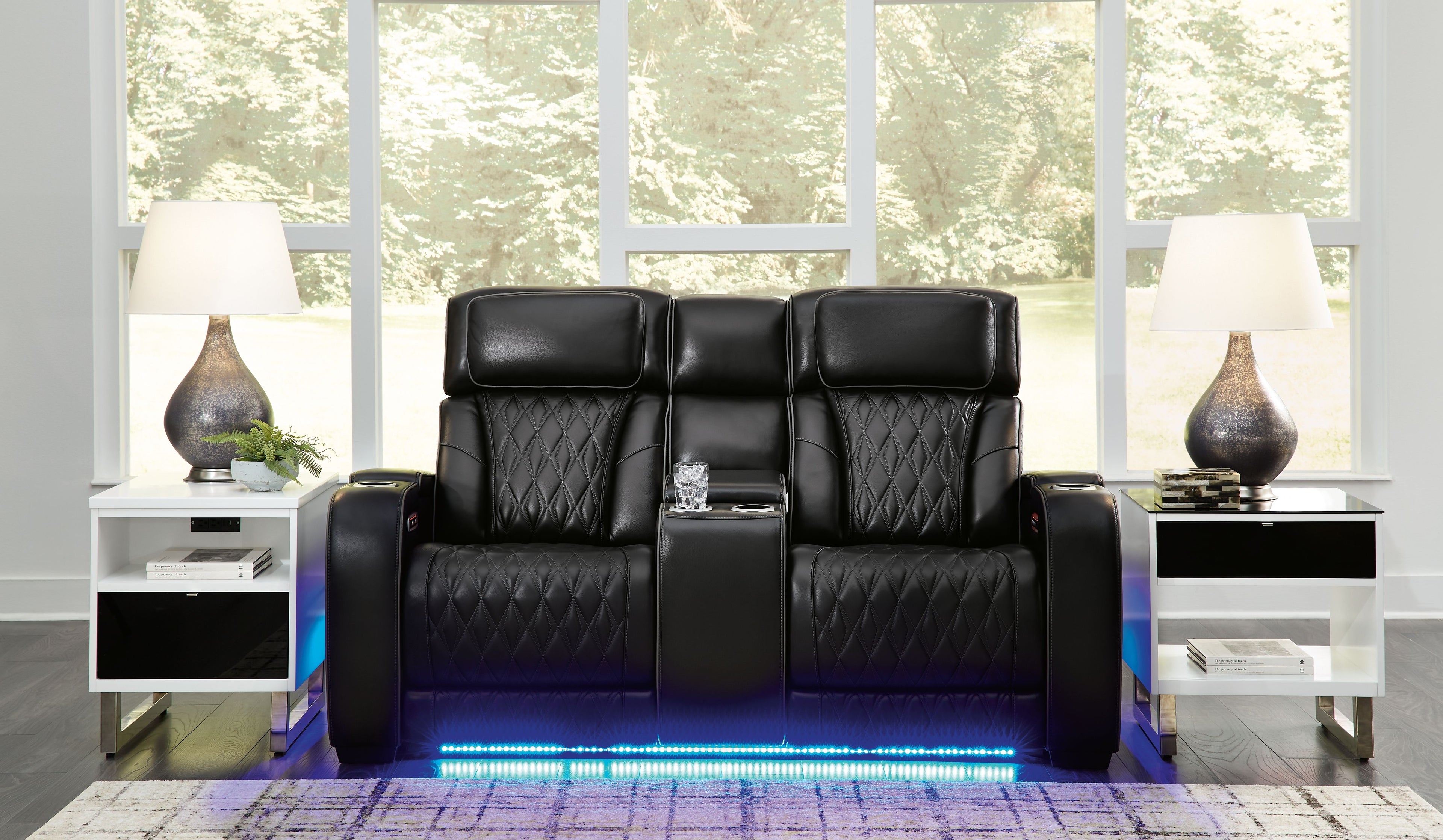 Black power reclining loveseat with console, quilted seats, and padded headrests
